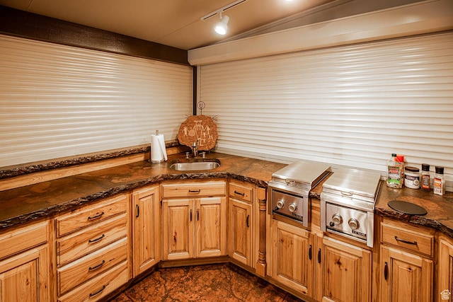 148 S Sunnybrook Dr, Salina, UT 84654 - kitchen featuring track lighting, dark stone counters, and brown cabinets