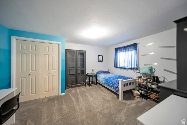carpeted bedroom featuring a textured ceiling
