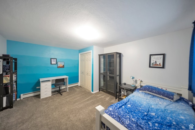 carpeted bedroom featuring baseboard heating, a textured ceiling, and a closet
