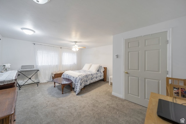 bedroom featuring ceiling fan and light carpet