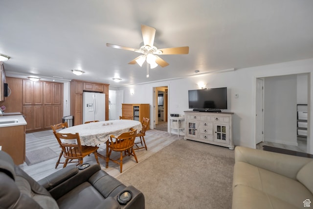 living room with light carpet and ceiling fan