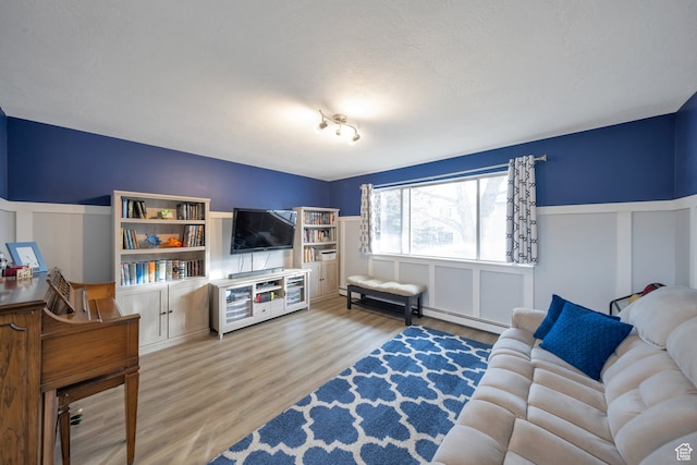 living room featuring a textured ceiling and hardwood / wood-style flooring