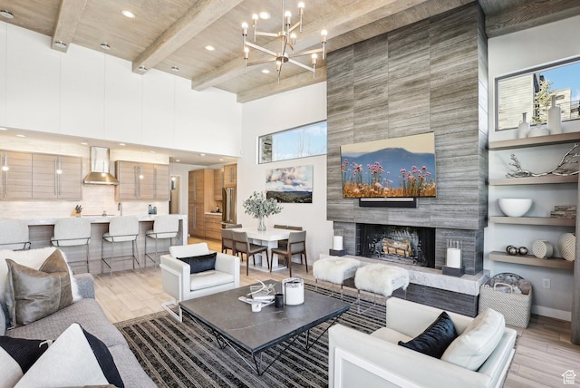 6412 Golden Bear Loop W, Park City, UT 84098 - living room with a towering ceiling, light wood-style floors, recessed lighting, a chandelier, and a fireplace