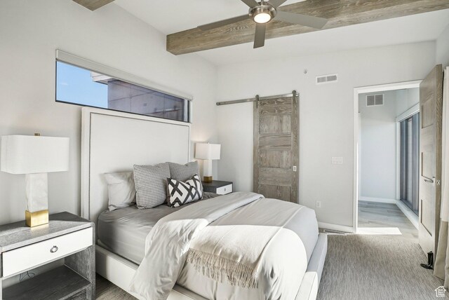 6412 Golden Bear Loop W, Park City, UT 84098 - bedroom with beam ceiling, a barn door, baseboards, ceiling fan, and light wood-style flooring