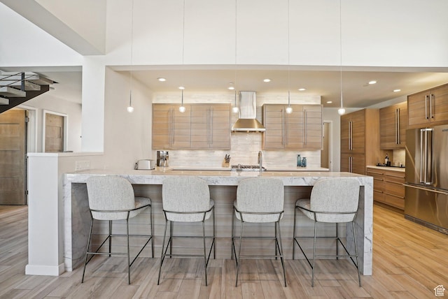 6412 Golden Bear Loop W, Park City, UT 84098 - kitchen featuring high quality fridge, wall chimney range hood, brown cabinetry, modern cabinets, and light wood-style flooring