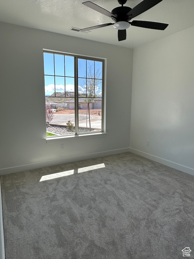 carpeted empty room with ceiling fan