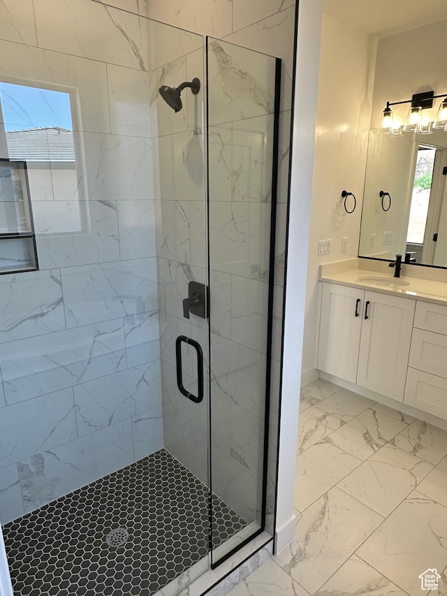 bathroom with a shower with door and vanity