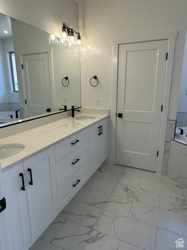 bathroom with a washtub and vanity