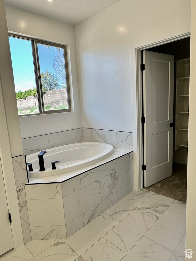 bathroom with tiled tub