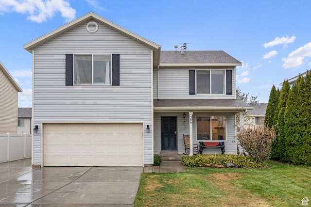 front of property featuring a front yard and a garage