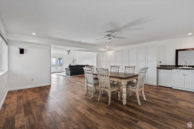 dining area featuring dark hardwood / wood-style flooring, ceiling fan, and sink