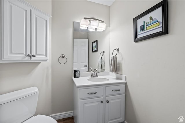 bathroom featuring vanity and toilet