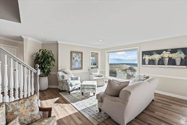 living room with hardwood / wood-style floors and ornamental molding