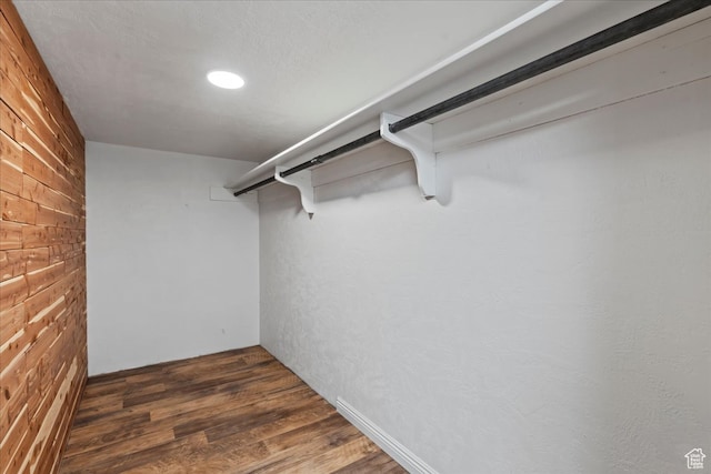 spacious closet with dark hardwood / wood-style floors
