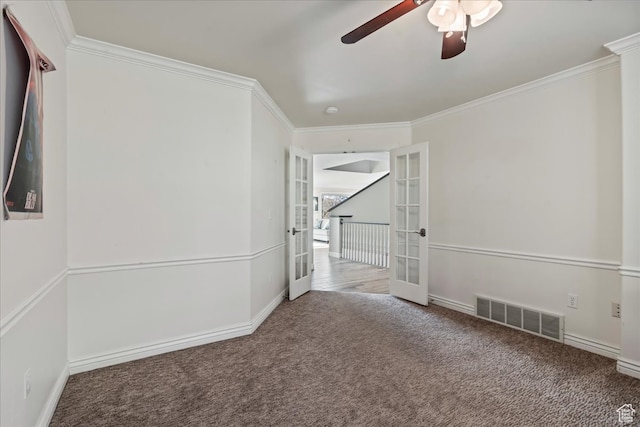 spare room featuring ceiling fan, carpet floors, ornamental molding, and french doors