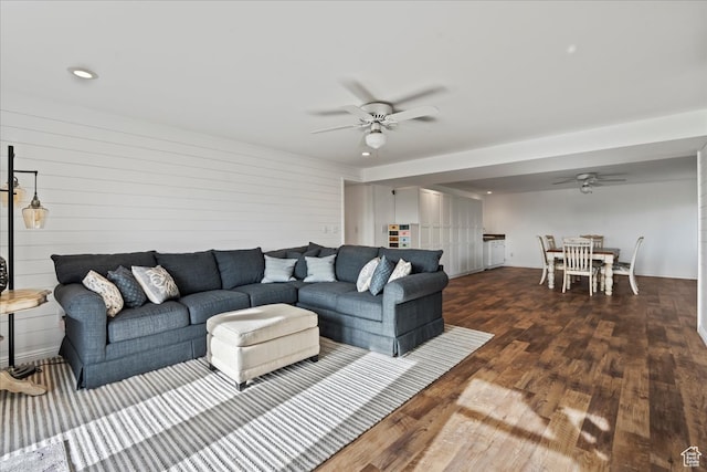 living room with dark hardwood / wood-style floors and ceiling fan