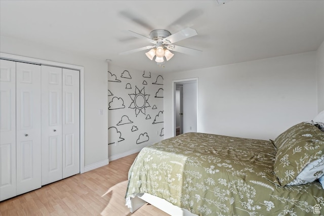 bedroom featuring a closet, light hardwood / wood-style floors, and ceiling fan