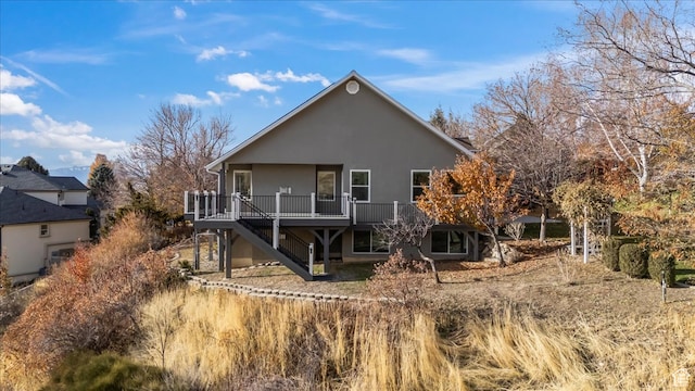 back of house featuring a wooden deck