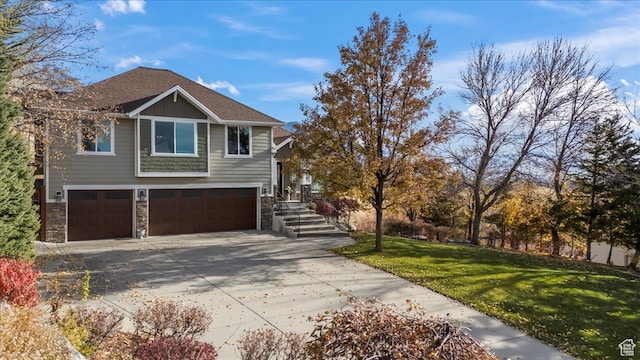 view of front of property with a front yard and a garage
