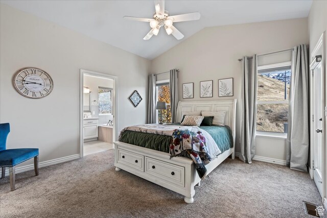 carpeted bedroom with ceiling fan, ensuite bathroom, and vaulted ceiling