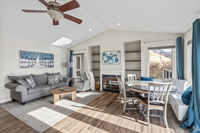 living room with ceiling fan, dark hardwood / wood-style floors, and lofted ceiling