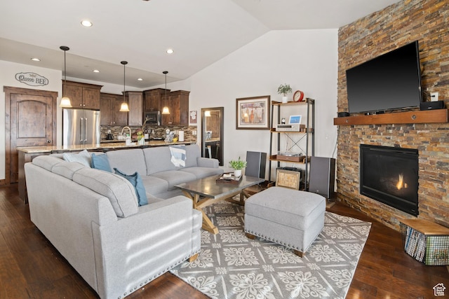 980 W White Cloud Trl, Hideout, UT 84036 - living room with vaulted ceiling, dark wood-style floors, a large fireplace, and recessed lighting