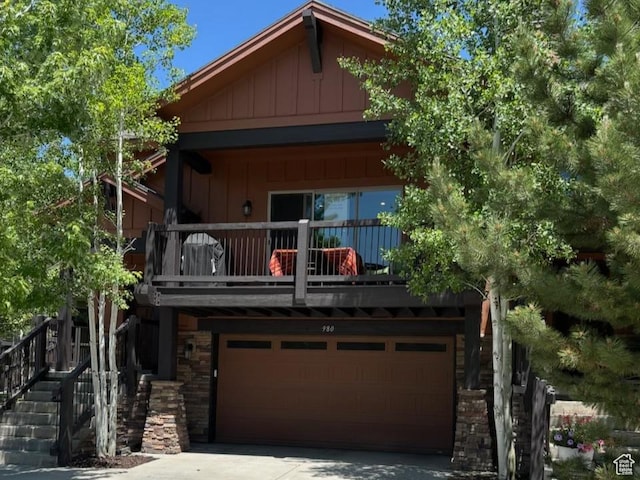 980 W White Cloud Trl, Hideout, UT 84036 - view of front facade with board and batten siding, a balcony, stone siding, driveway, and stairway