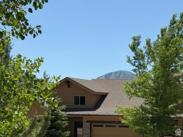 980 W White Cloud Trl, Hideout, UT 84036 - view of home's exterior with roof with shingles, stone siding, and a mountain view