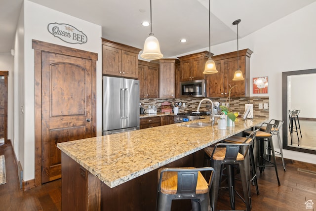 980 W White Cloud Trl, Hideout, UT 84036 - kitchen featuring light stone counters, dark hardwood / wood-style flooring, decorative light fixtures, and appliances with stainless steel finishes