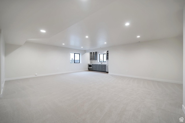 176 S 1150 E, Pleasant Grove, UT 84062 - unfurnished living room featuring recessed lighting, light colored carpet, baseboards, and a sink