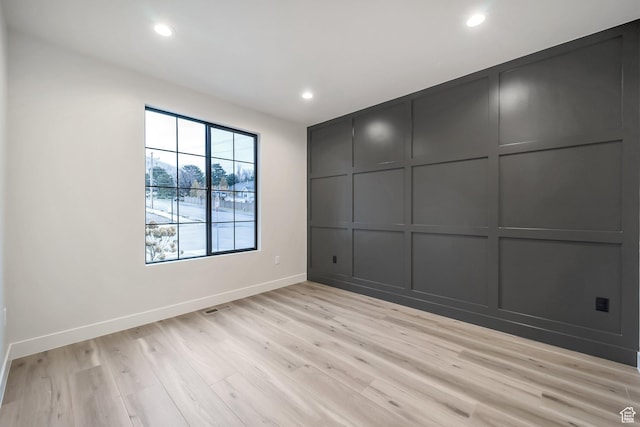 176 S 1150 E, Pleasant Grove, UT 84062 - unfurnished bedroom featuring light wood-style floors, baseboards, recessed lighting, and a decorative wall