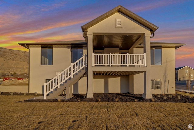 176 S 1150 E, Pleasant Grove, UT 84062 - back of property at dusk with stucco siding, stairs, and a deck