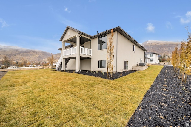 176 S 1150 E, Pleasant Grove, UT 84062 - back of house with a mountain view, a lawn, stucco siding, a balcony, and central AC unit