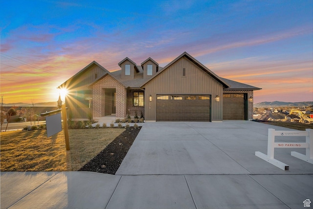 176 S 1150 E, Pleasant Grove, UT 84062 - view of front of house with a garage, driveway, board and batten siding, and brick siding