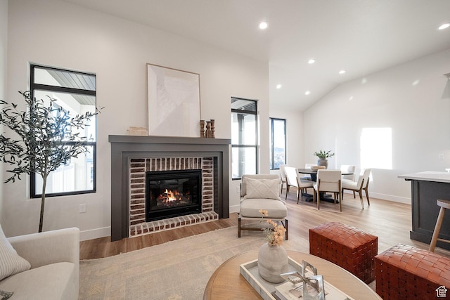 176 S 1150 E, Pleasant Grove, UT 84062 - living room featuring lofted ceiling, healthy amount of natural light, a fireplace, light wood-type flooring, and recessed lighting
