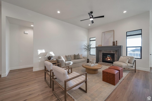176 S 1150 E, Pleasant Grove, UT 84062 - living area with light wood finished floors, a fireplace, recessed lighting, a ceiling fan, and baseboards