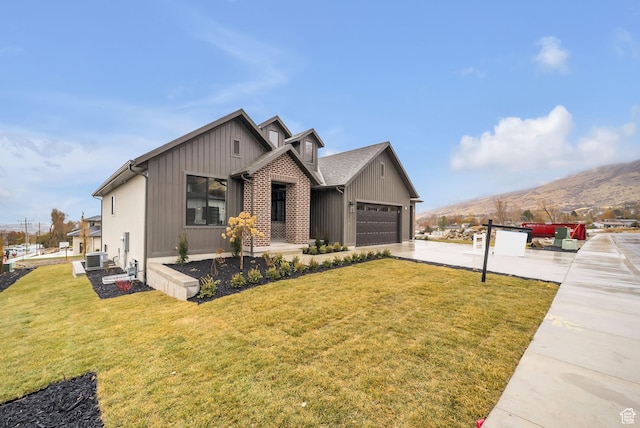 176 S 1150 E, Pleasant Grove, UT 84062 - view of front of house featuring a garage, driveway, a front lawn, a mountain view, and cooling unit