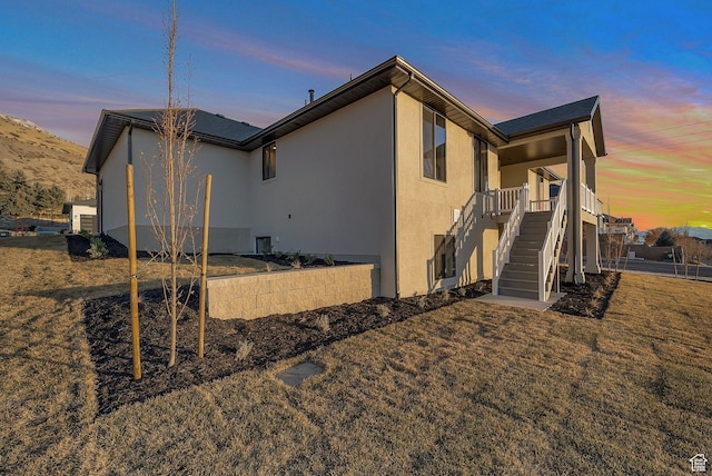 176 S 1150 E, Pleasant Grove, UT 84062 - property exterior at dusk featuring stairs, stucco siding, and a lawn