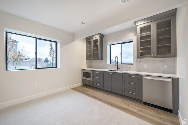 176 S 1150 E, Pleasant Grove, UT 84062 - kitchen with appliances with stainless steel finishes, a sink, gray cabinets, light countertops, and glass insert cabinets