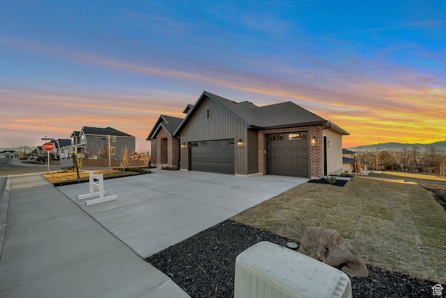 176 S 1150 E, Pleasant Grove, UT 84062 - view of property exterior featuring board and batten siding, a garage, concrete driveway, brick siding, and a mountain view