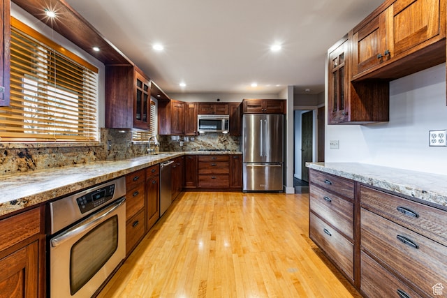 1983 E 1700 S, Salt Lake City, UT 84108 - kitchen featuring appliances with stainless steel finishes, a sink, light wood finished floors, light stone counters, and recessed lighting