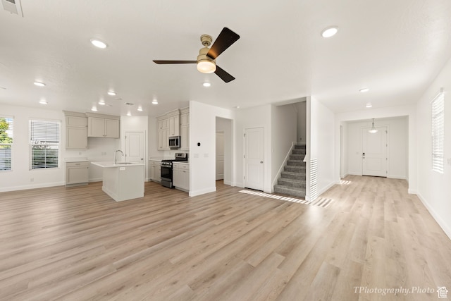 660 W Cypress Umber Dr, St George, UT 84790 - unfurnished living room with visible vents, a sink, light wood-type flooring, stairway, and recessed lighting