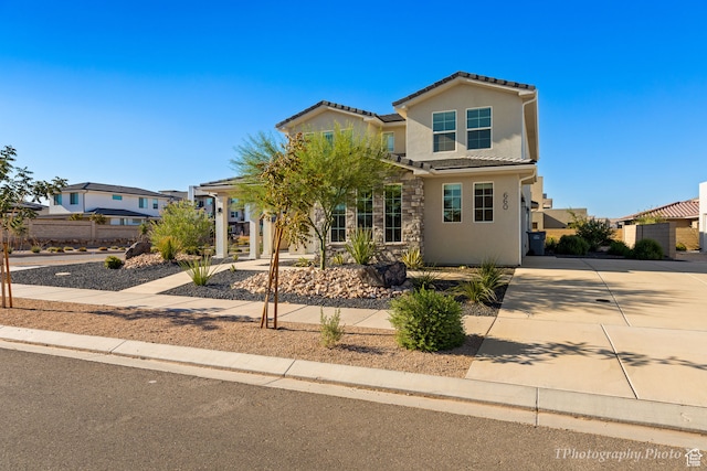 660 W Cypress Umber Dr, St George, UT 84790 - traditional home featuring stone siding, a tiled roof, stucco siding, and fence