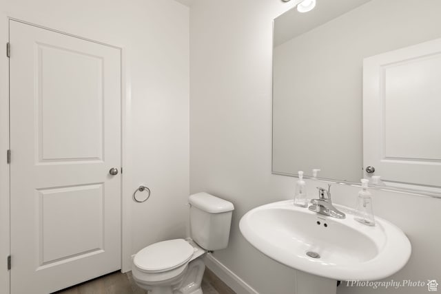 660 W Cypress Umber Dr, St George, UT 84790 - half bath featuring baseboards, a sink, toilet, and wood finished floors
