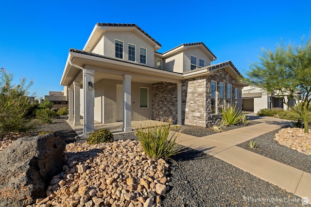 660 W Cypress Umber Dr, St George, UT 84790 - view of front of house with covered porch, stucco siding, stone siding, and a tile roof