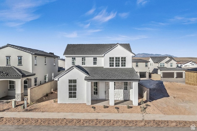 652 W Emerald Point Dr Unit 131, St George, UT 84790 - view of front of home featuring stone siding, stucco siding, covered porch, a tile roof, and a residential view