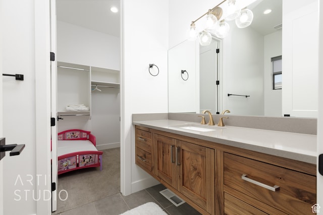 bathroom featuring visible vents, connected bathroom, tile patterned floors, vanity, and a closet