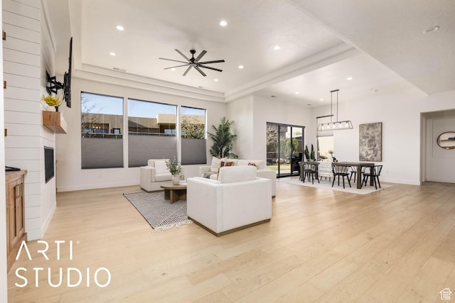 living room with light wood finished floors, baseboards, and recessed lighting