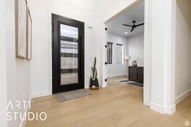 entrance foyer featuring light wood-type flooring, ceiling fan, and baseboards