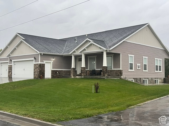 355 S 200 W, Orangeville, UT 84537 - craftsman house featuring a porch, a garage, and a front lawn